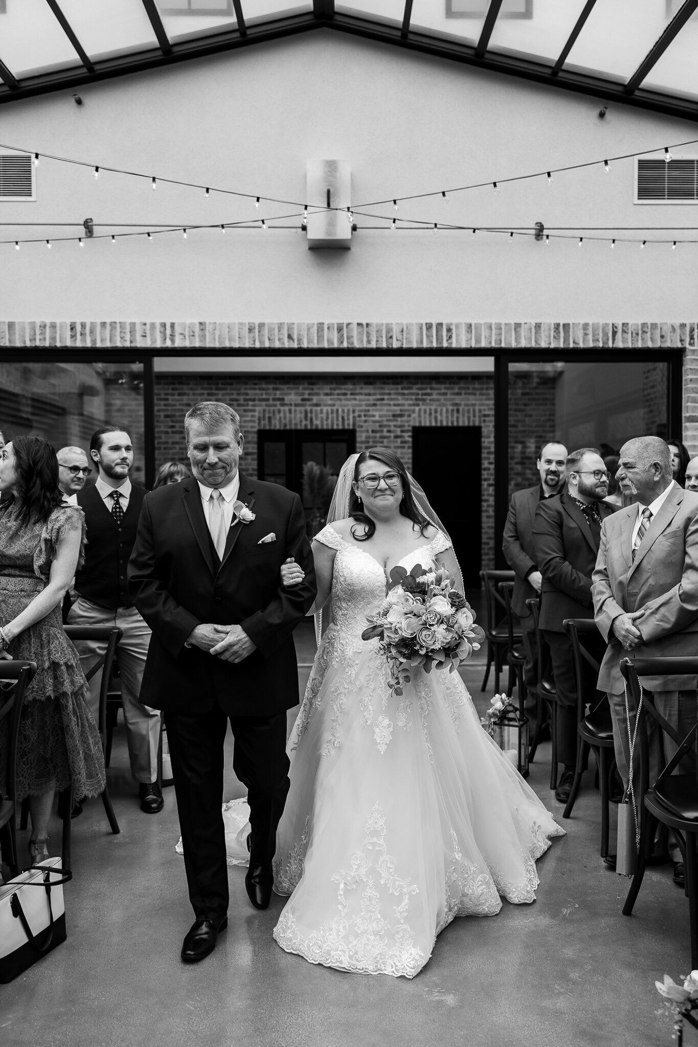 Emotional black and white photo of the bride’s father walking her down the aisle at Perona Farms