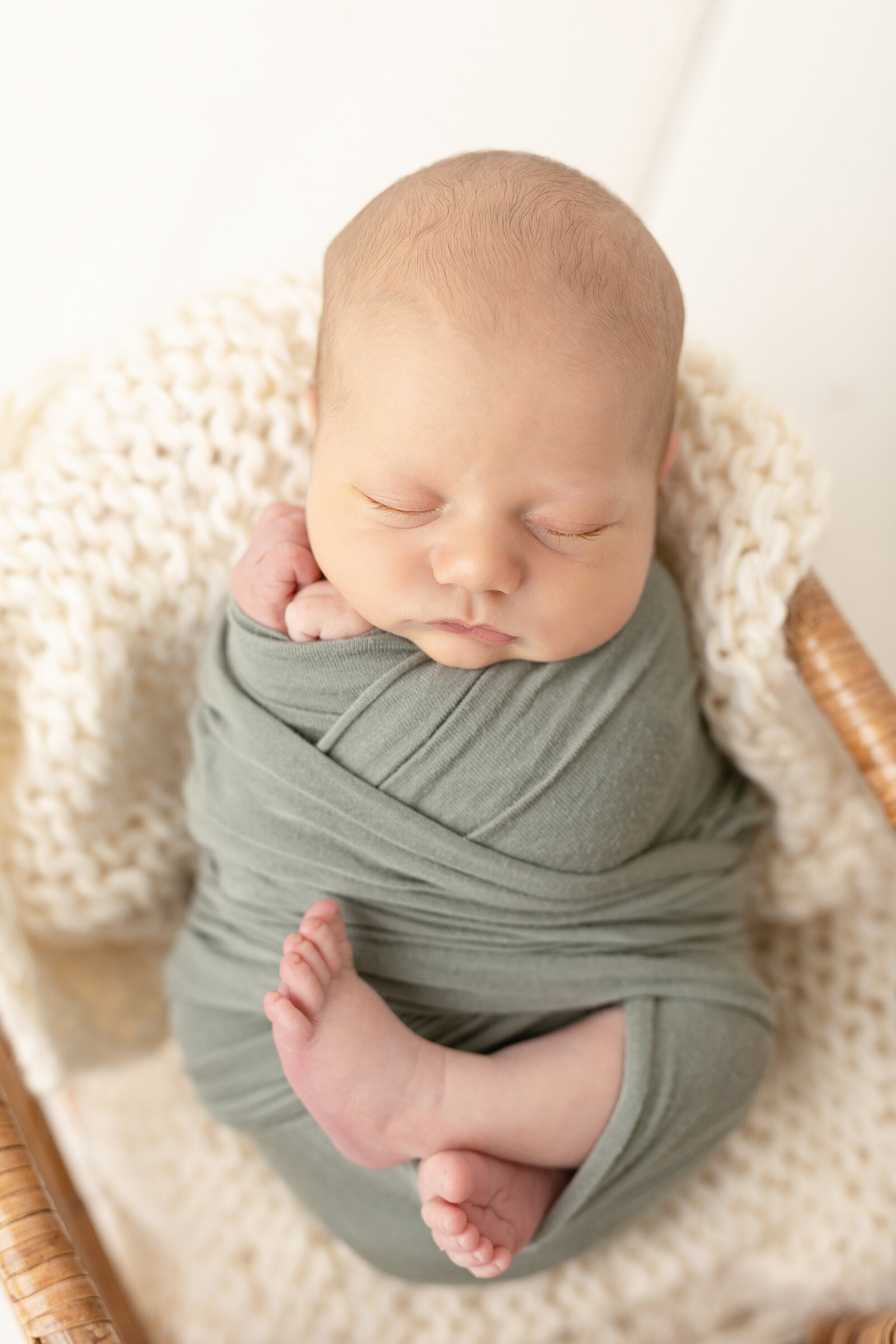 newborn baby boy in sage green wrap