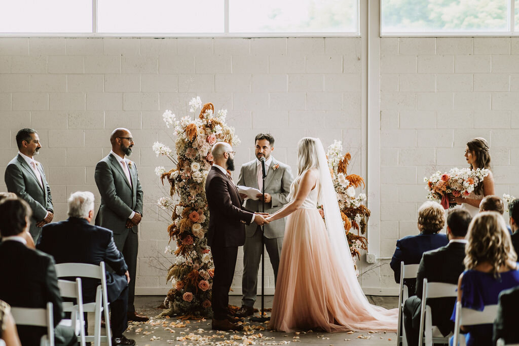 Ceremony-bride-groom-pink-dress-elegant-floral-officiant