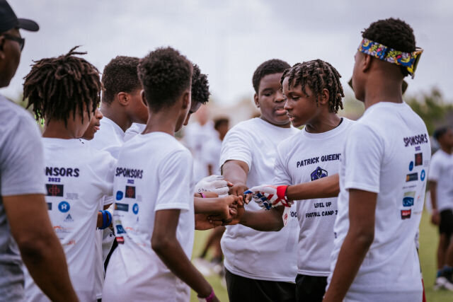fellas in huddle during football camp