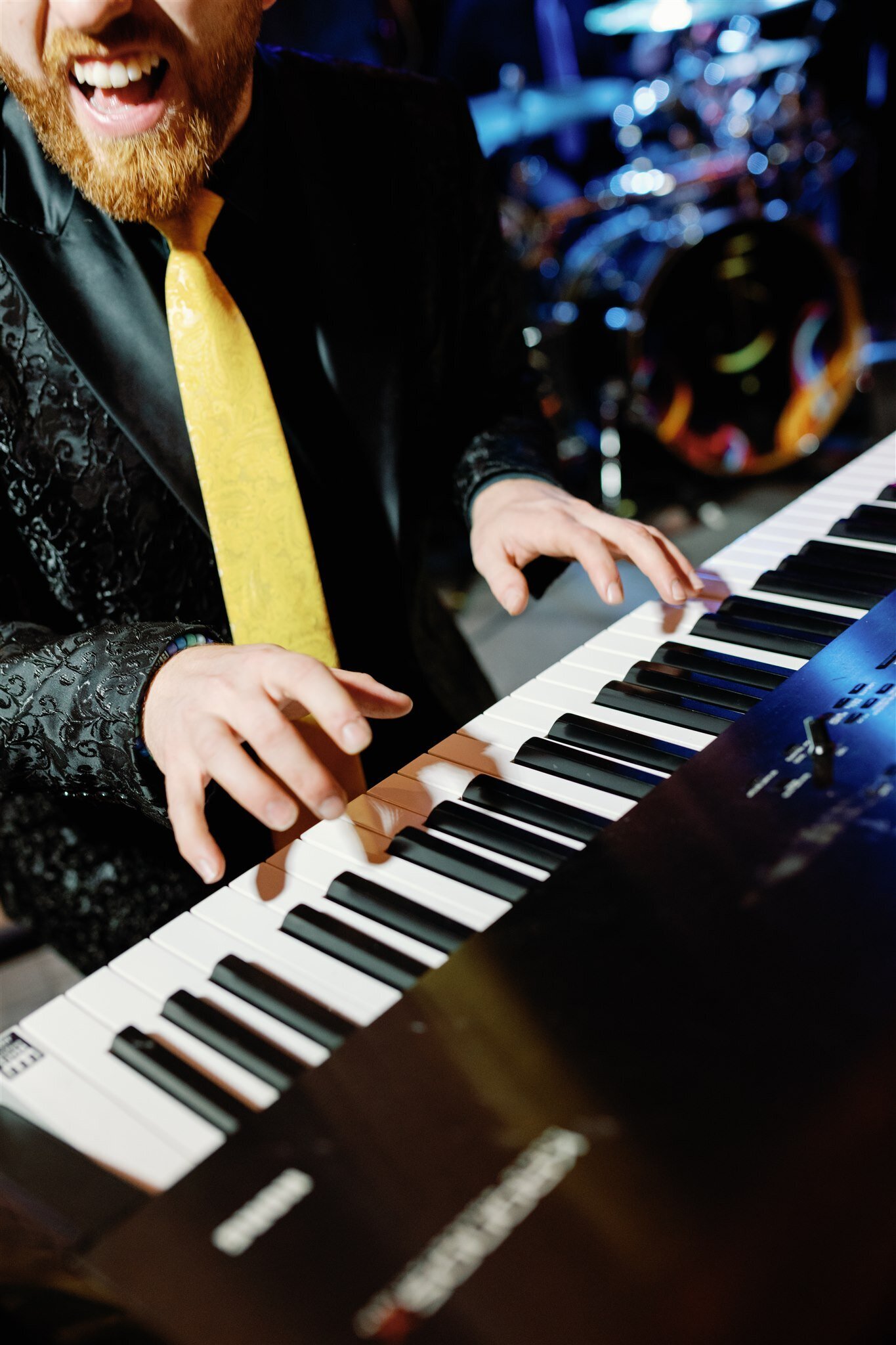 A band member playing the keyboard at a wedding reception on Mackinac Island