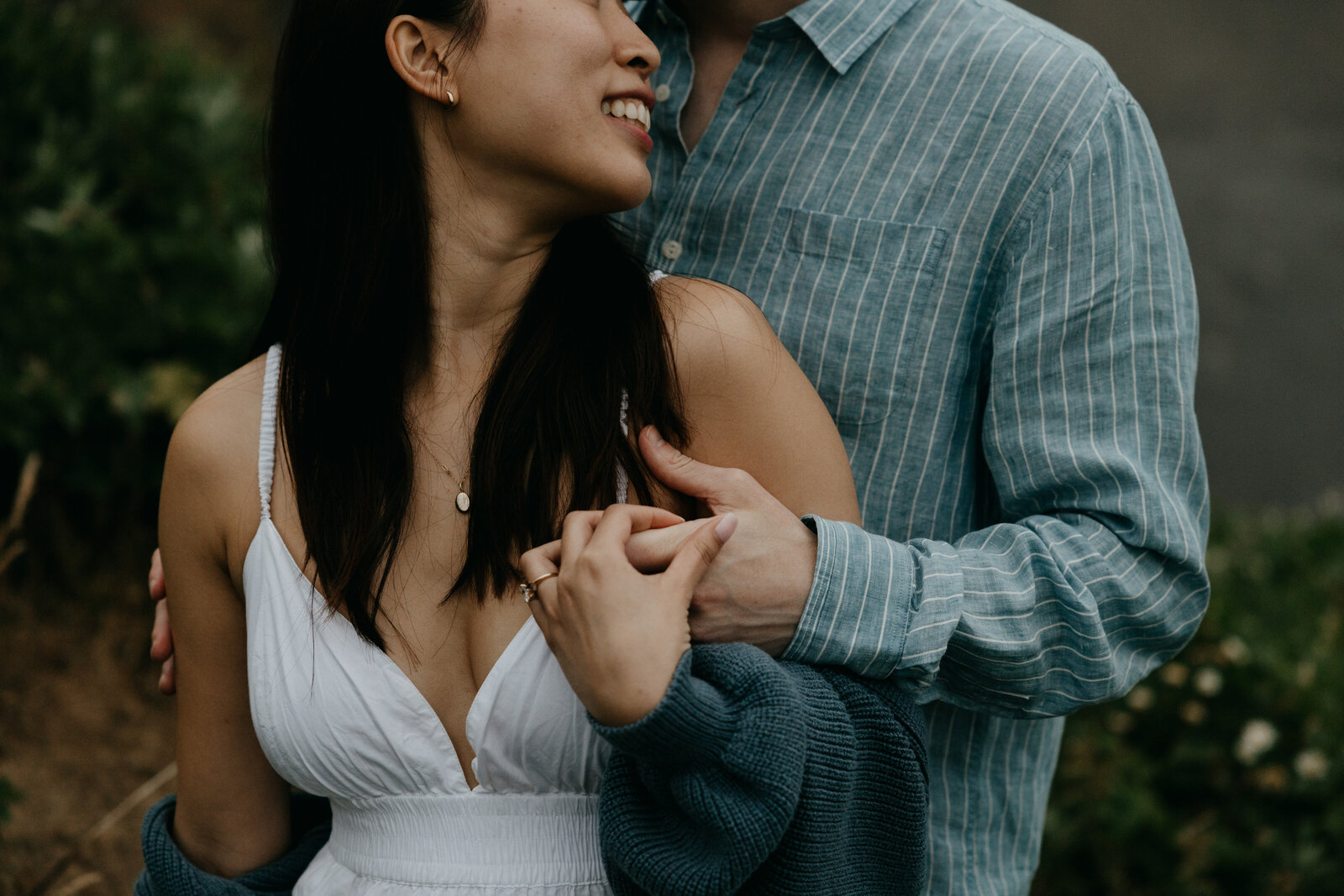 engaged couple at the Oregon Coast  on a moody cloudy day