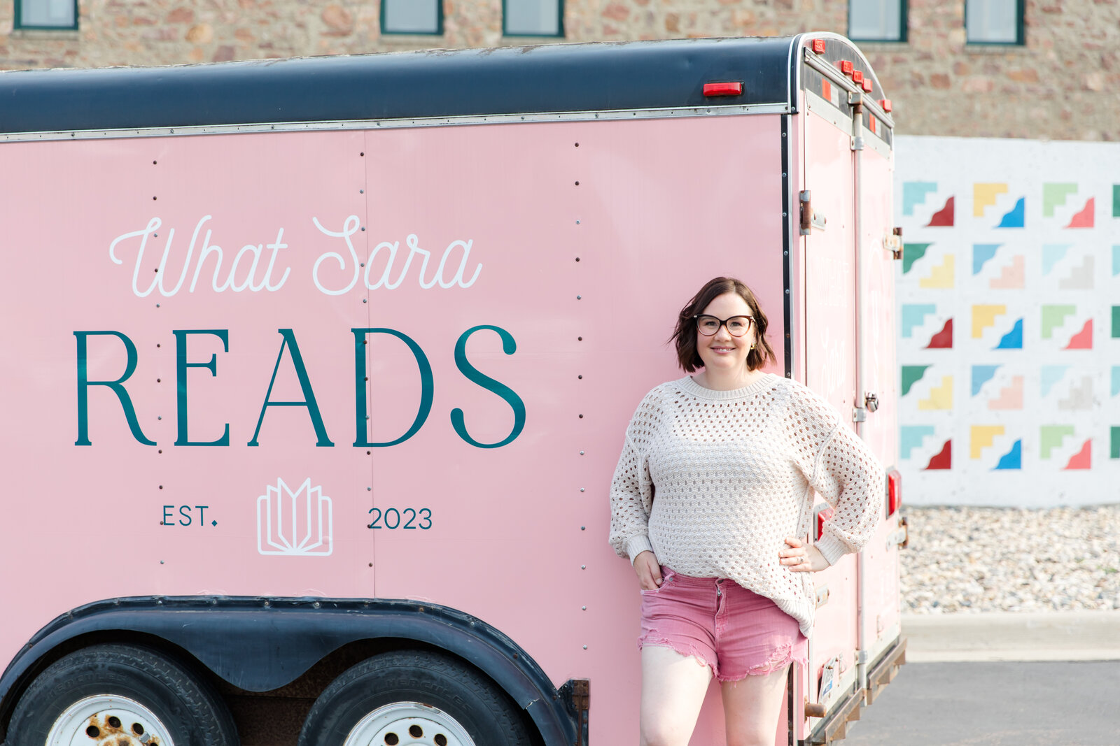 What Sara Reads owner Sara Gillis standing in front of mobile book trailer