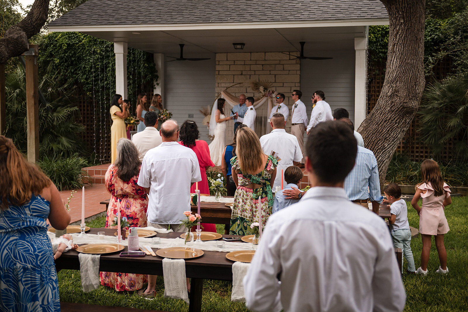 Wedding guests gathering for an outdoor ceremony in a scenic San Antonio venue, captured by CMH Studios.