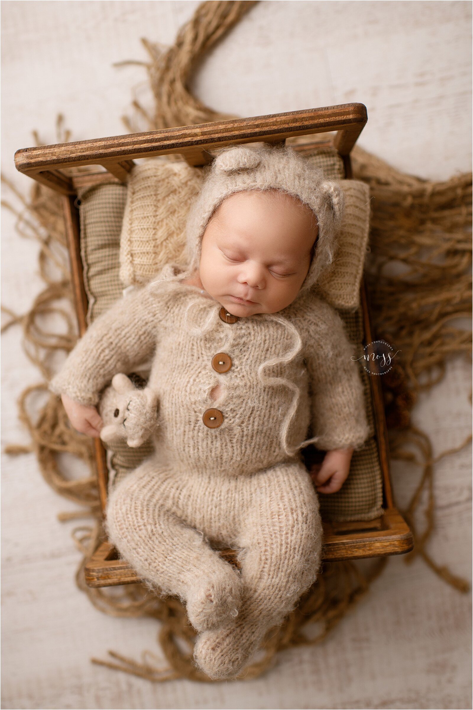 newborn baby in bear onesie