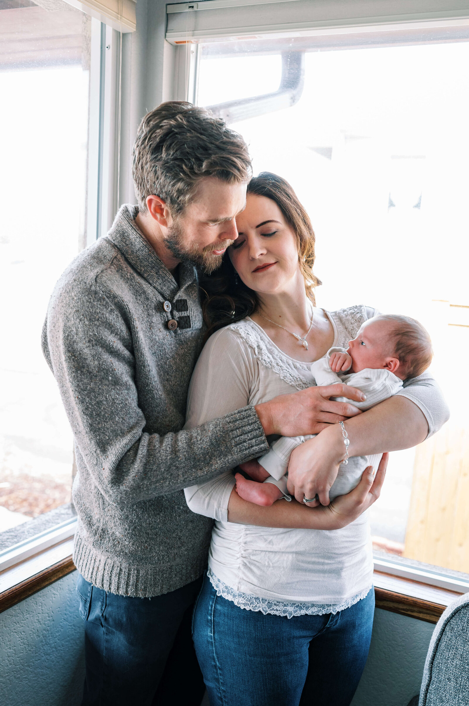 A family hugs their newborn son in an image by Northern Virginia family photographer, Erin Winter