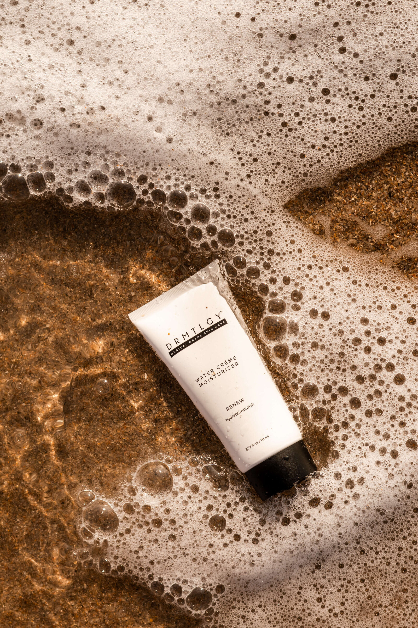 DRMTLGY skincare product photography on sand