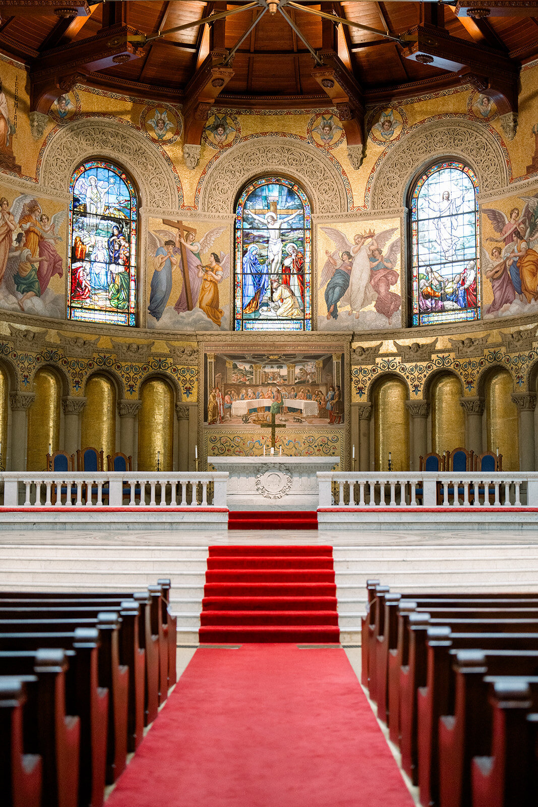 A grand wedding ceremony held at the breathtaking Stanford Memorial Church, highlighting the majestic stained-glass windows and architecture.