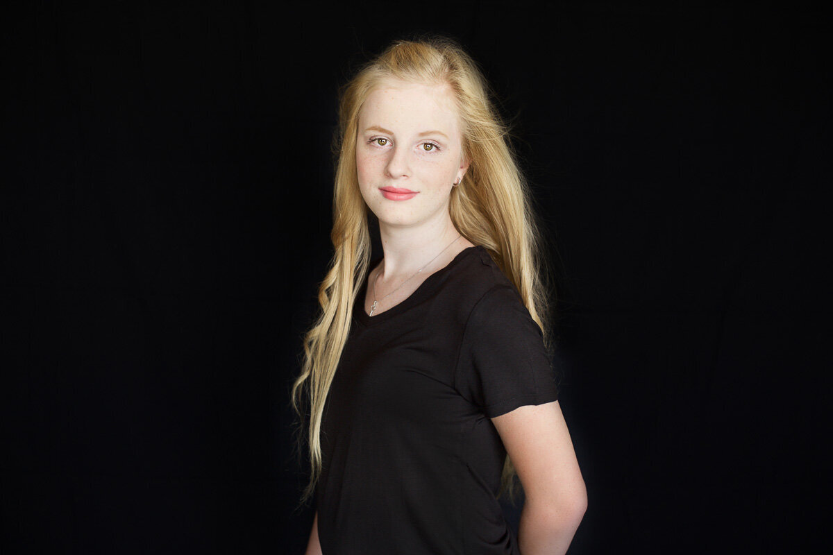 Teen girl with blond long hair portrait in Calgary photo studio by Yuliia Terziian Photography