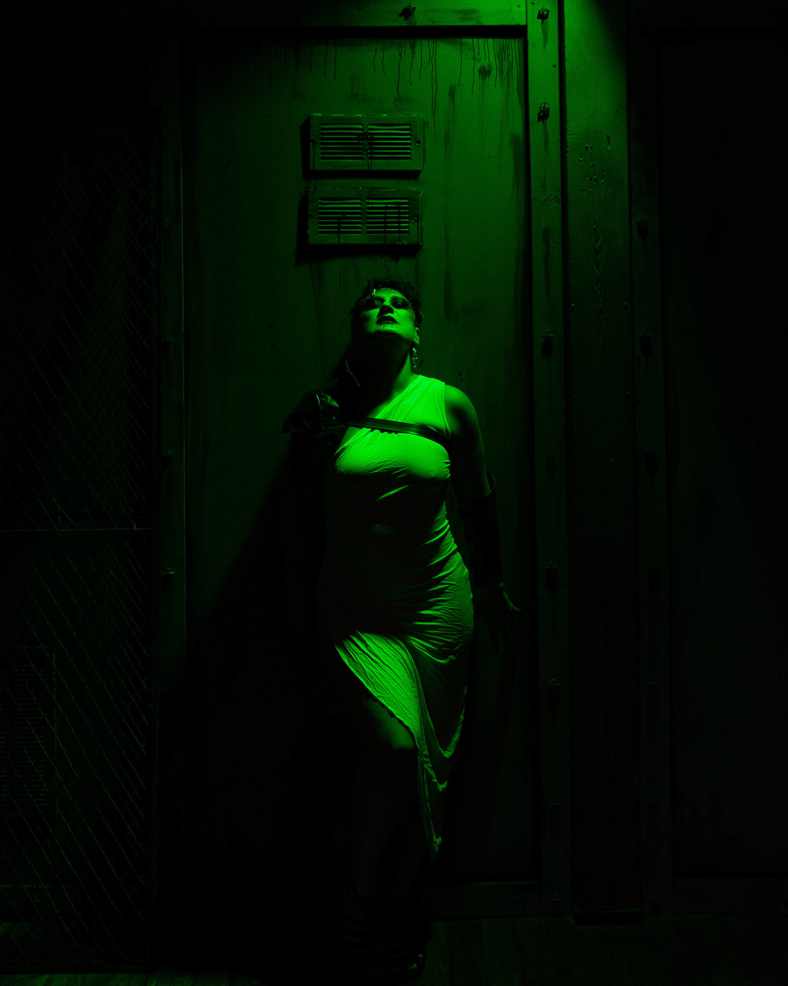 scary looking woman in a green light room