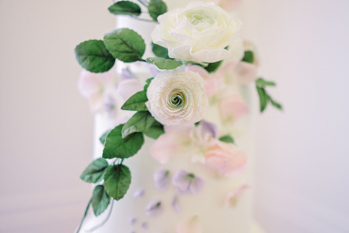 photo of elegant wedding cake featuring floral accents