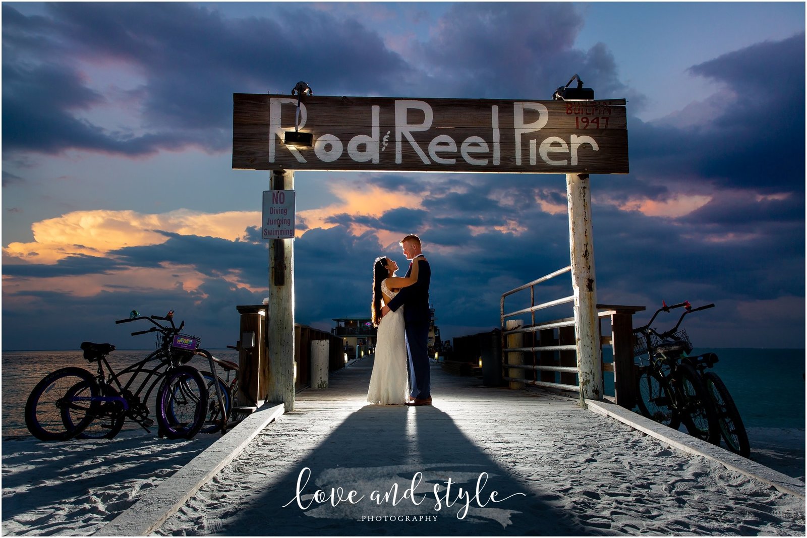 Rod and Reel Pier Wedding Photography of bride and groom with backlight at sunset