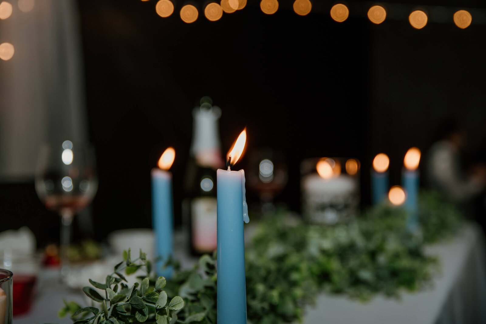 Blue candles lit on tablescape.
