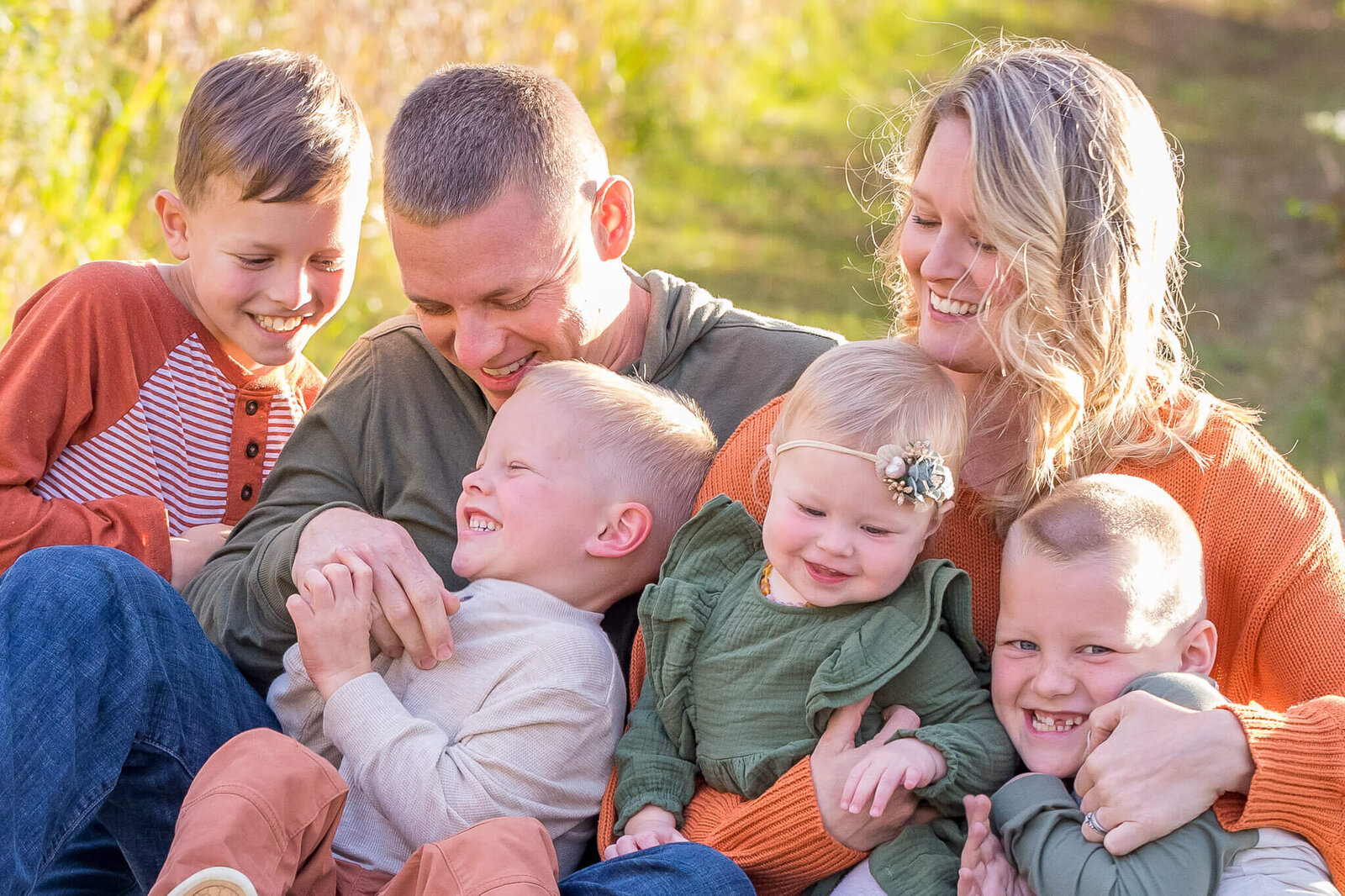 A family of six snuggling and tickling each other during a Haymarket family photography session.