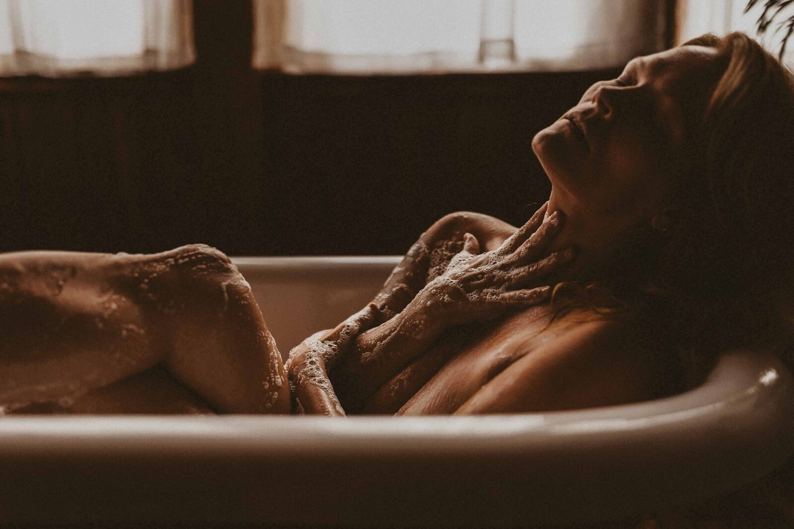 woman in a bathtub with bubbles in her body