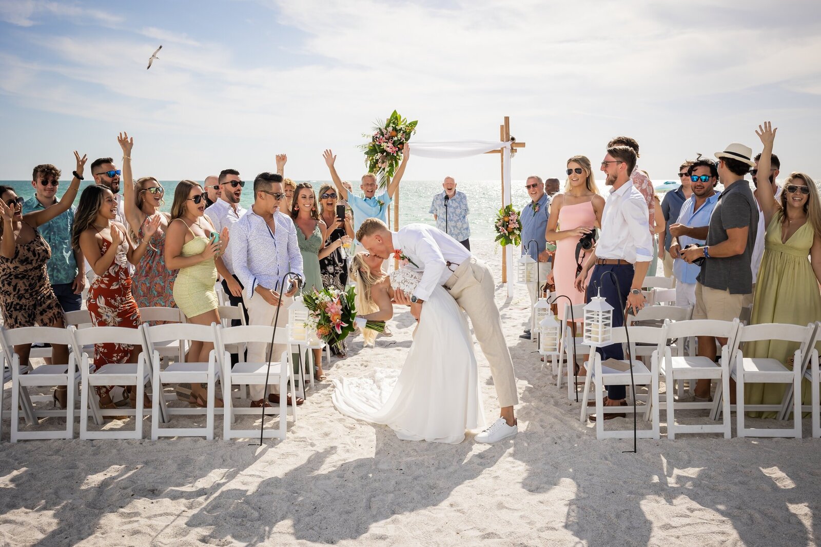Bride and groom kissing at the end of the aisle on Anna Maria Island