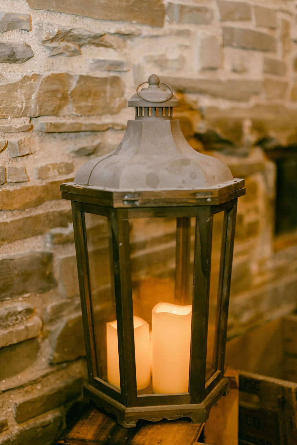 patina galvenized lantern with candles in a stone barn in Upstate