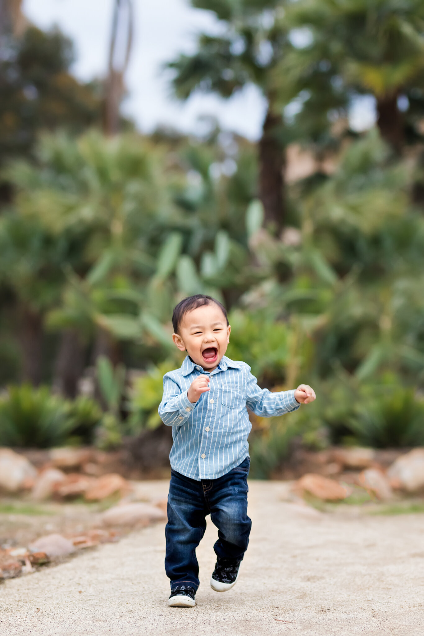 Baby boy running in a garden in San Diego