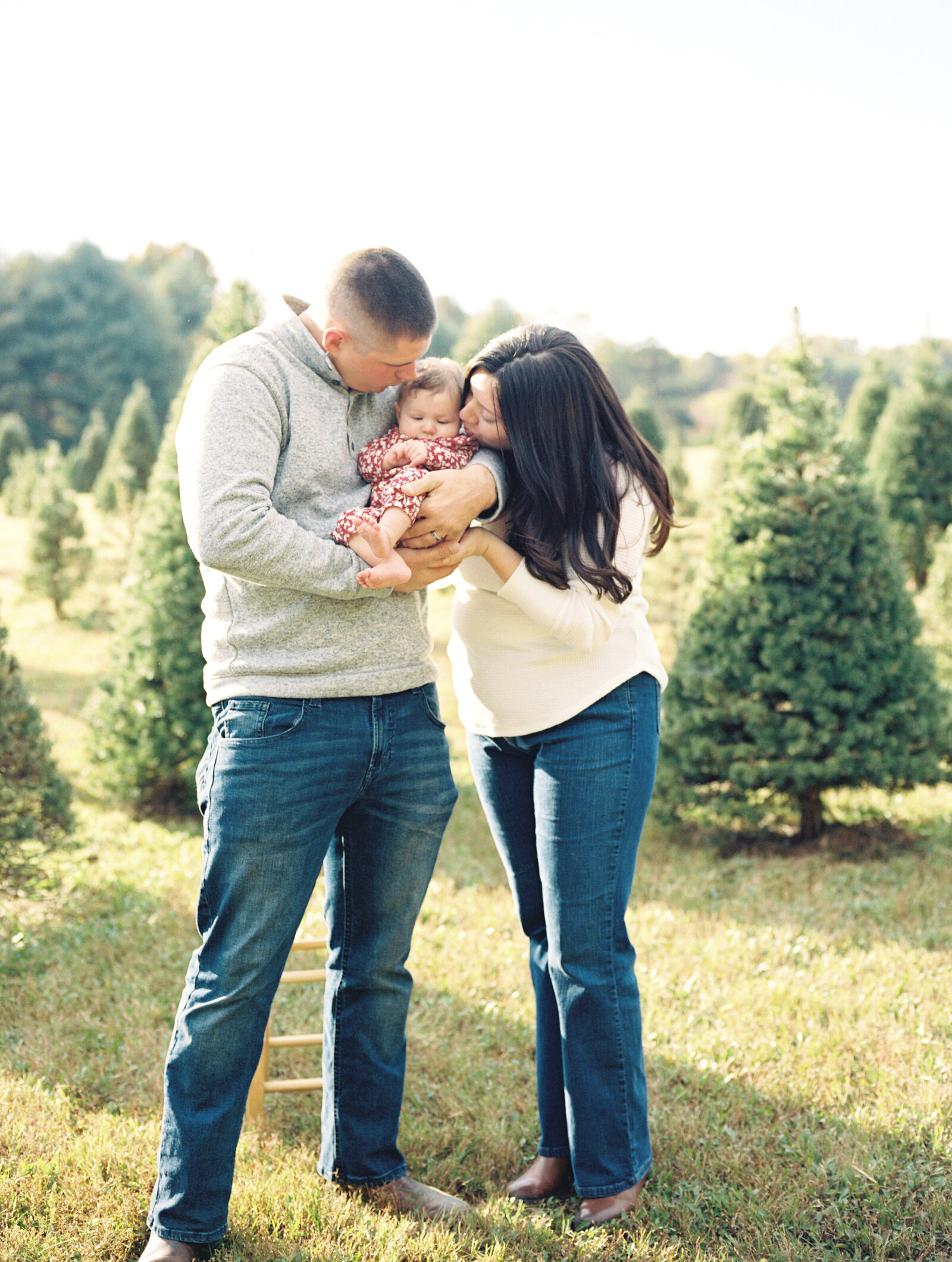 holiday photo of parents with newborn