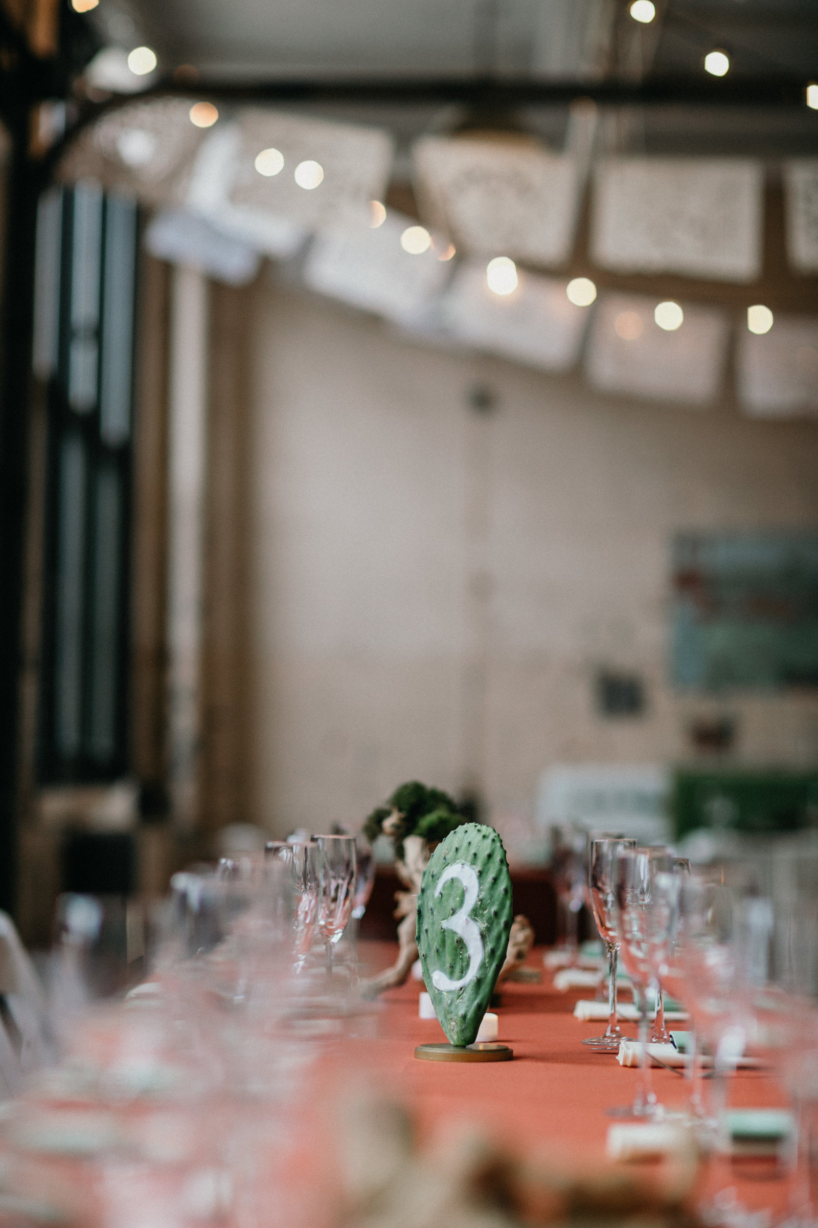 Hand painted cactus table pieces, in this industrial Philadelphia wedding venue.