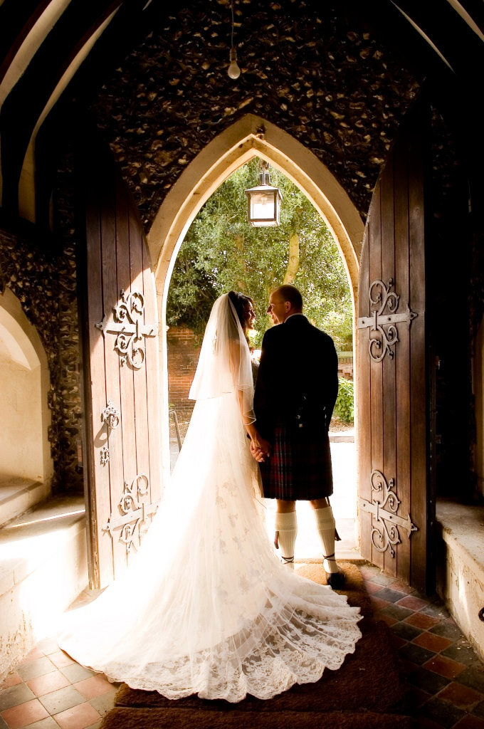 bride and groom by door