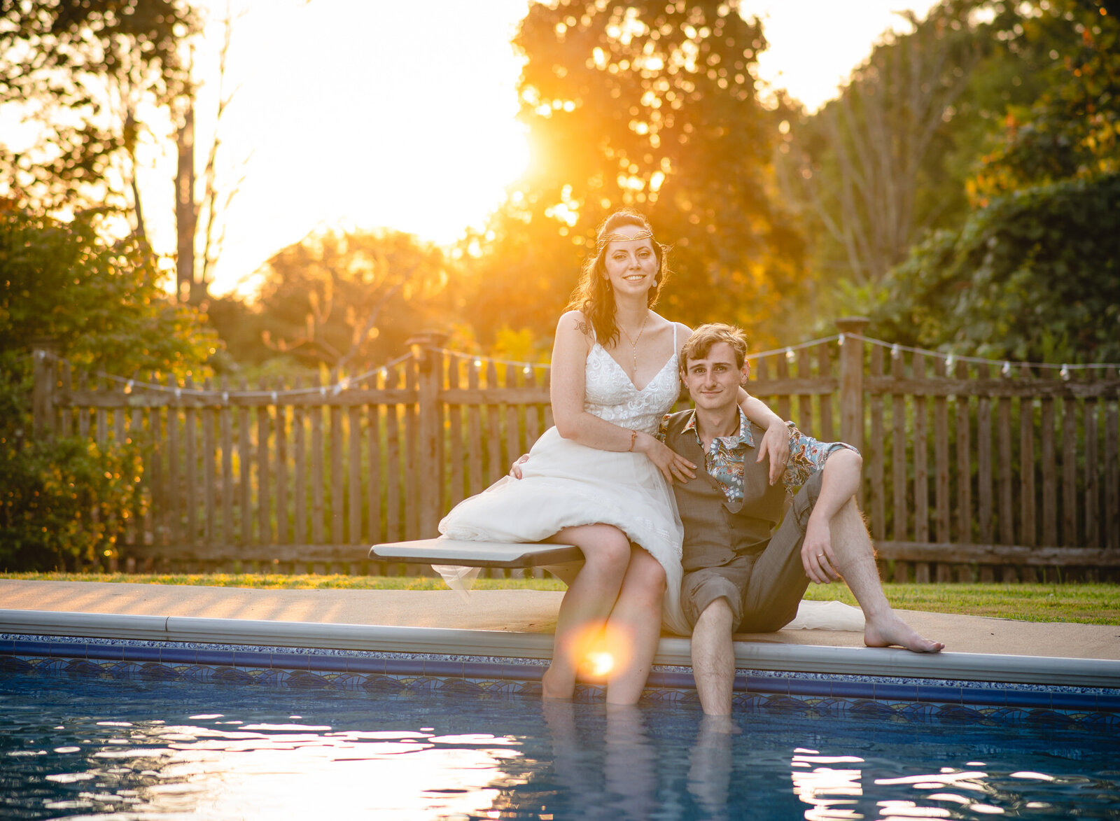 wedding couple sitting poolside in New England