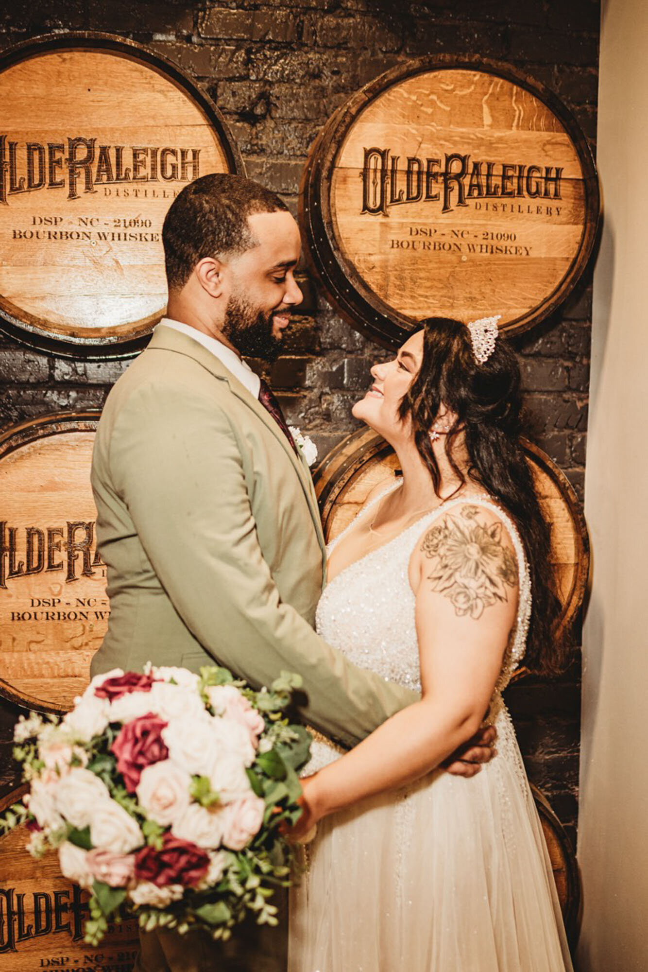 Bride and groom in front of wine barrels in Raleigh North Carolina