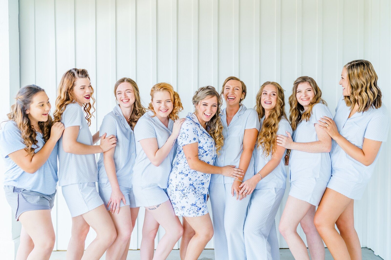 Bridal party laughing in powder blue outfits at New England Wedding