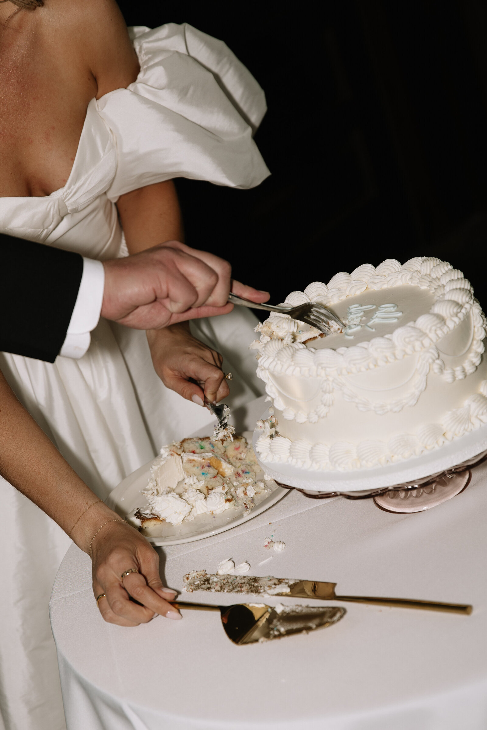 Cake cutting moment of bride and groom during Idaho wedding reception