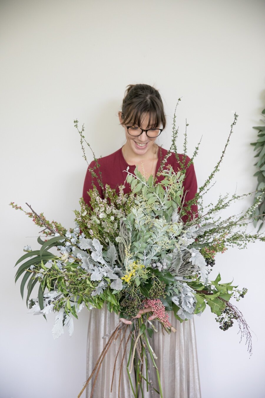 Woman holding large bouquet of wild flowers