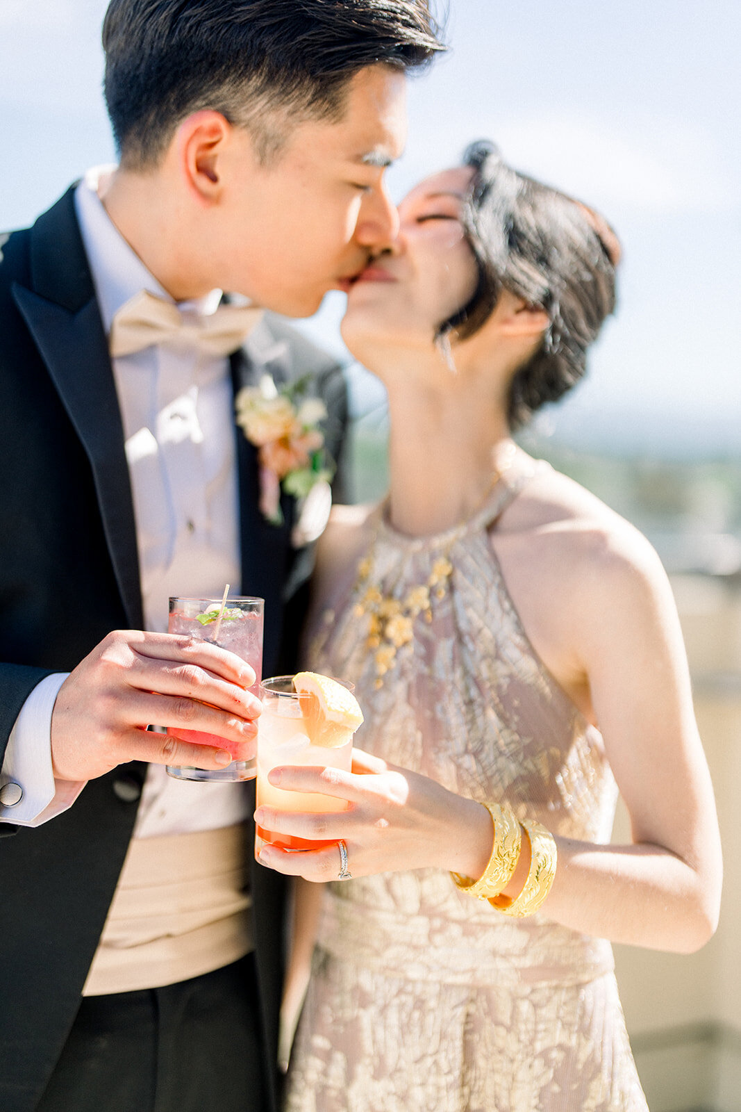 The bride and groom share a celebratory toast, capturing a moment of joy and love during their wedding day at Stanford University and Filoli estate.