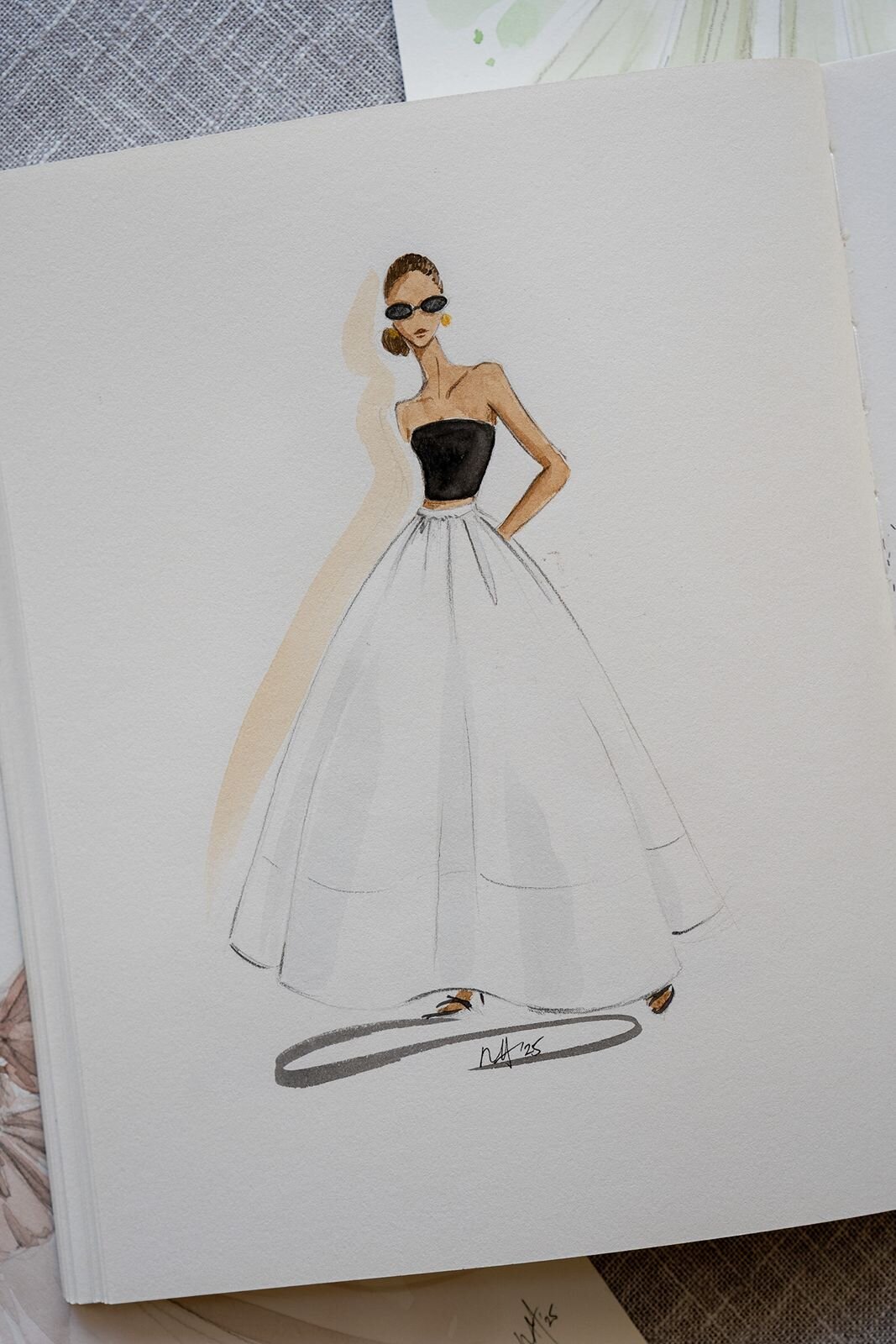 Watercolor fashion illustration of a girl in a black top and white long skirt.