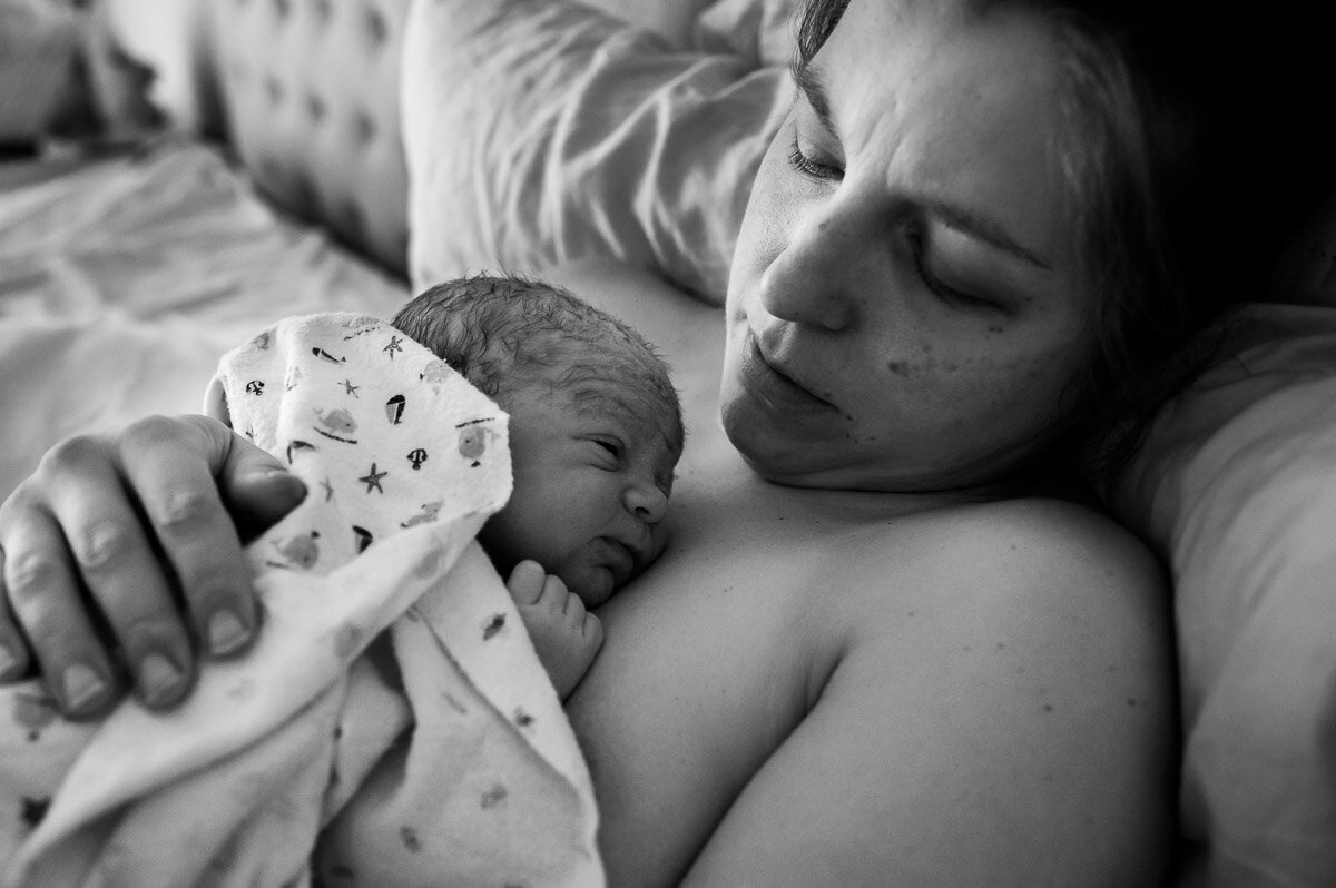 mom resting with newborn after homebirth in New Braunfels