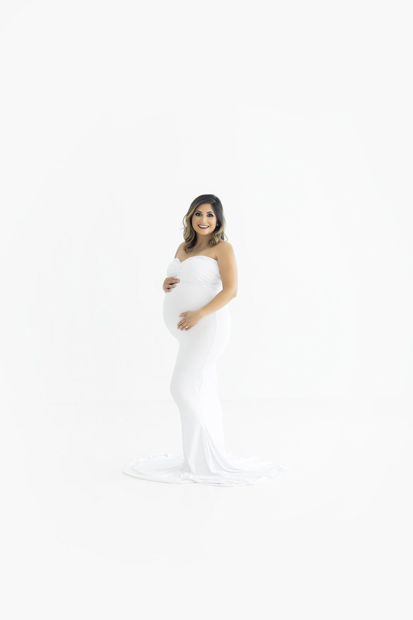 Maternity session in white studio, a Dallas maternity photographer.