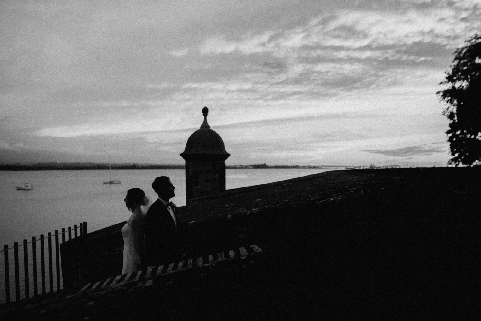 A couple near the ocean and a garrita in Old San Juan, Puerto Rico.