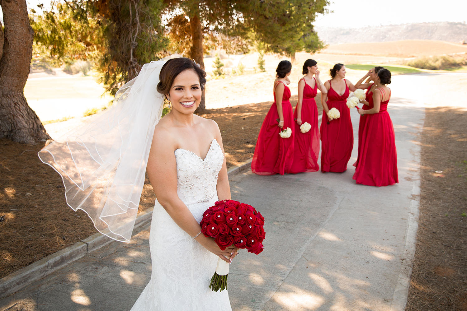 bride with bridesmaids in red dresses