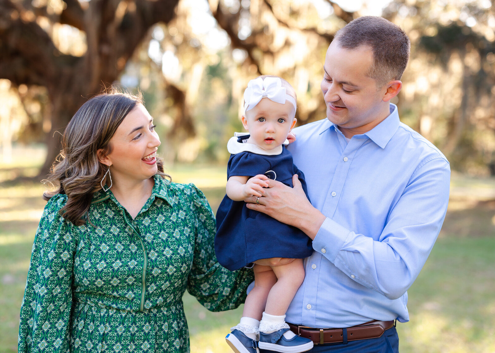 Family of 3 with one year old girl smiling at the camera at Grace Community Church in Rincon, Ga