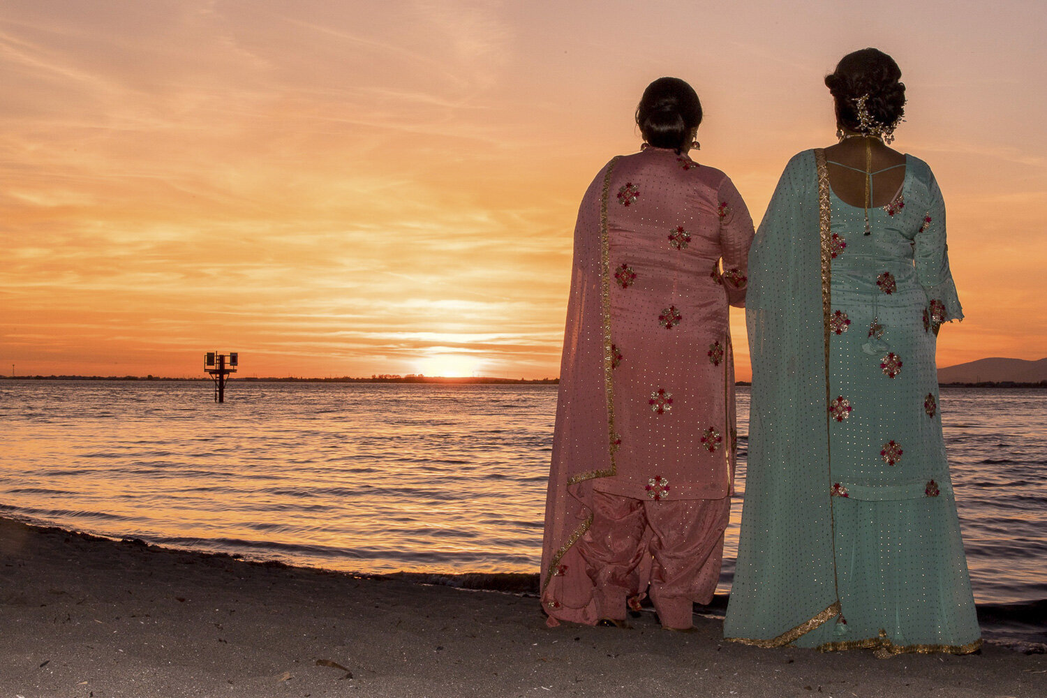 two women looking at a sunset
