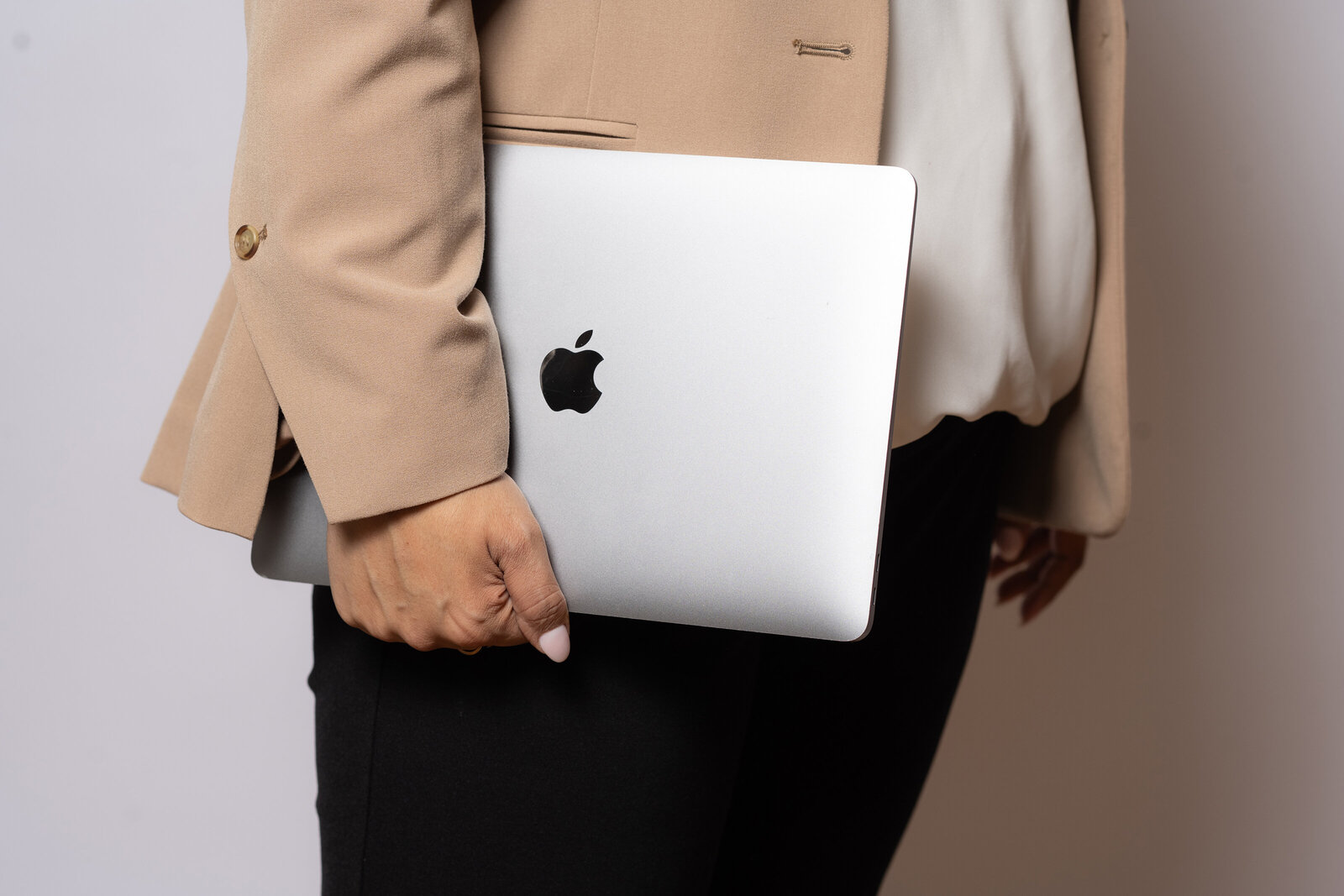 The expertise of a business consultant, adorned in an elegant blazer and equipped with a laptop