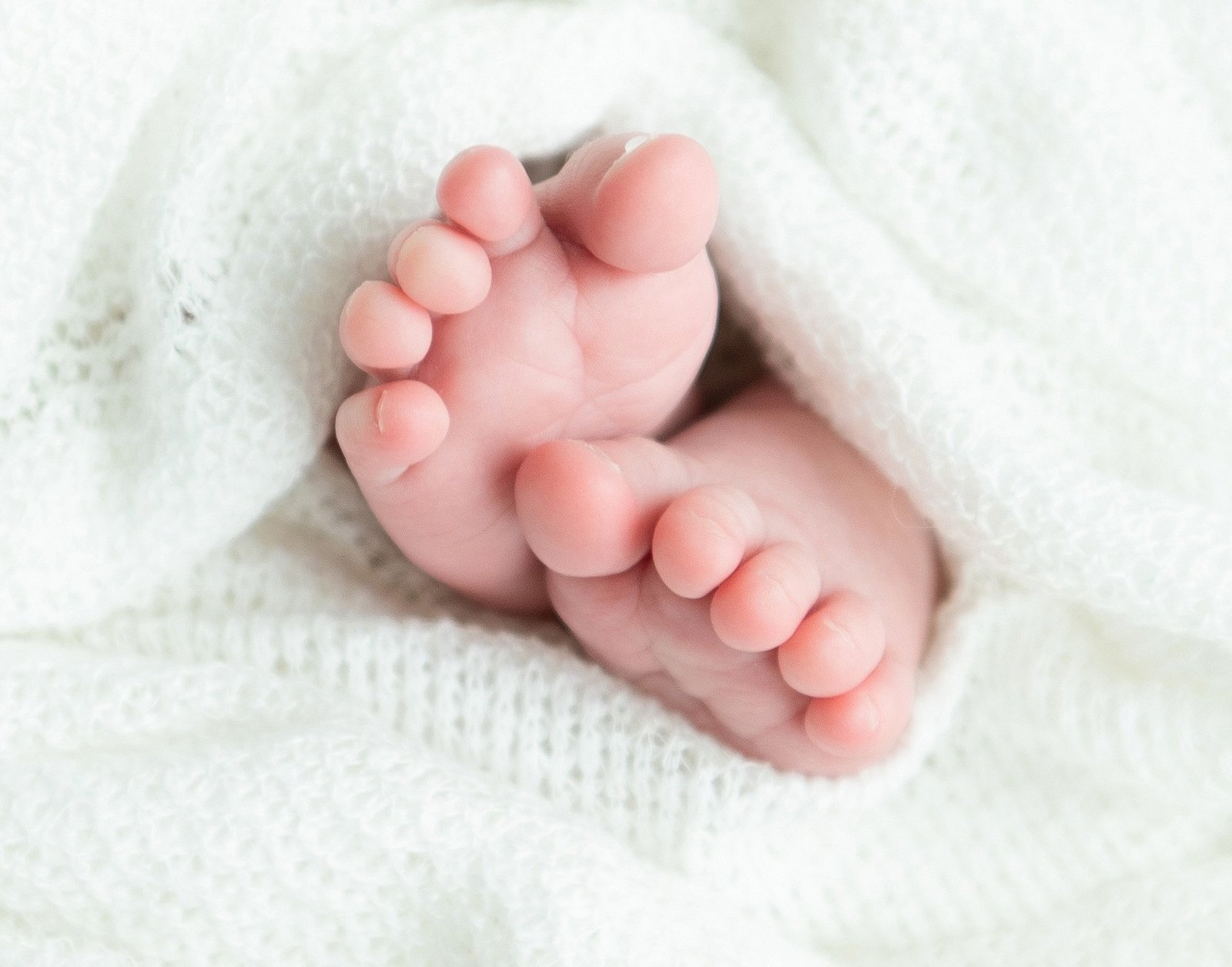 close up image of a baby's toes wrapped in a blanket