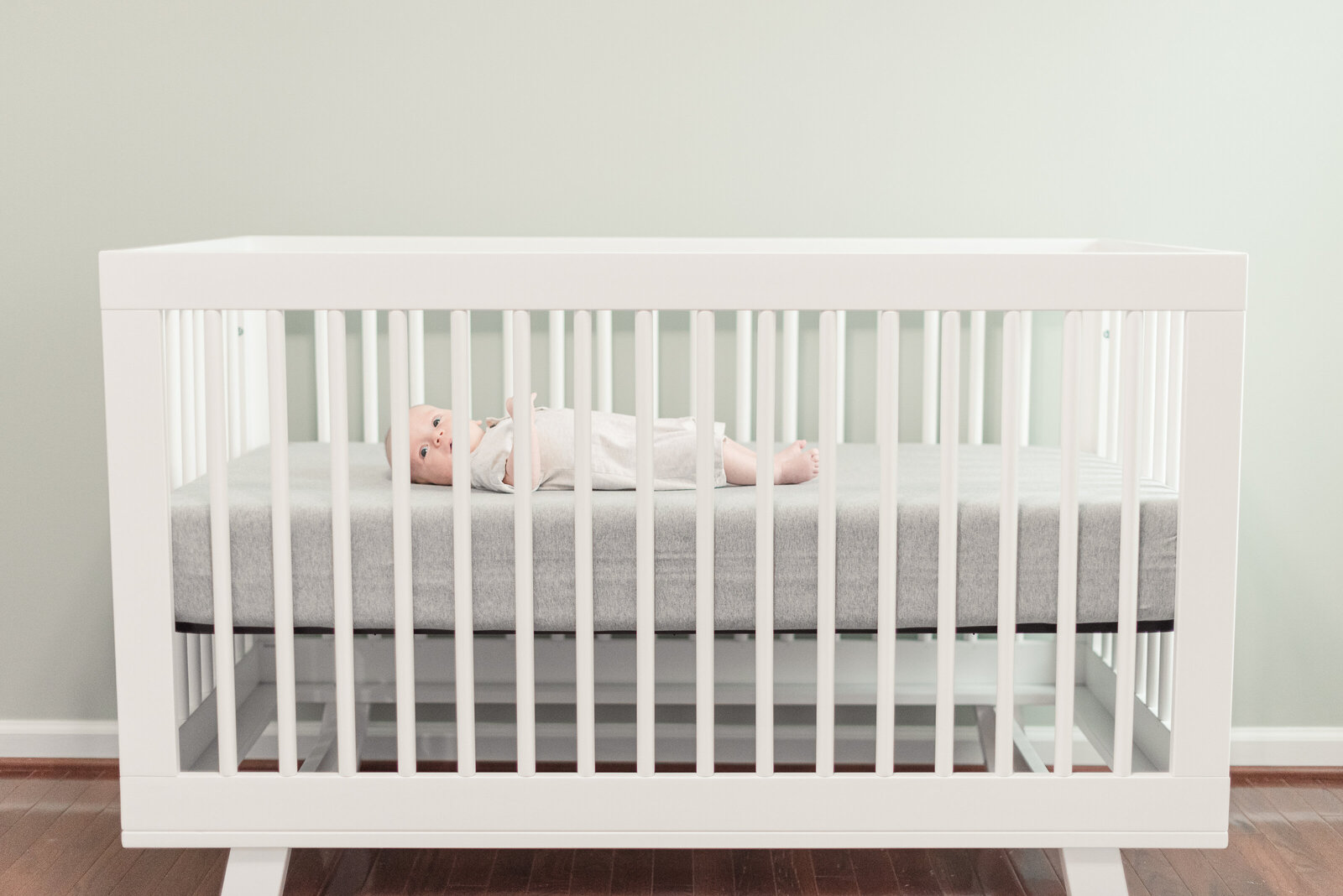 View of newborn Laying in crib in nursery