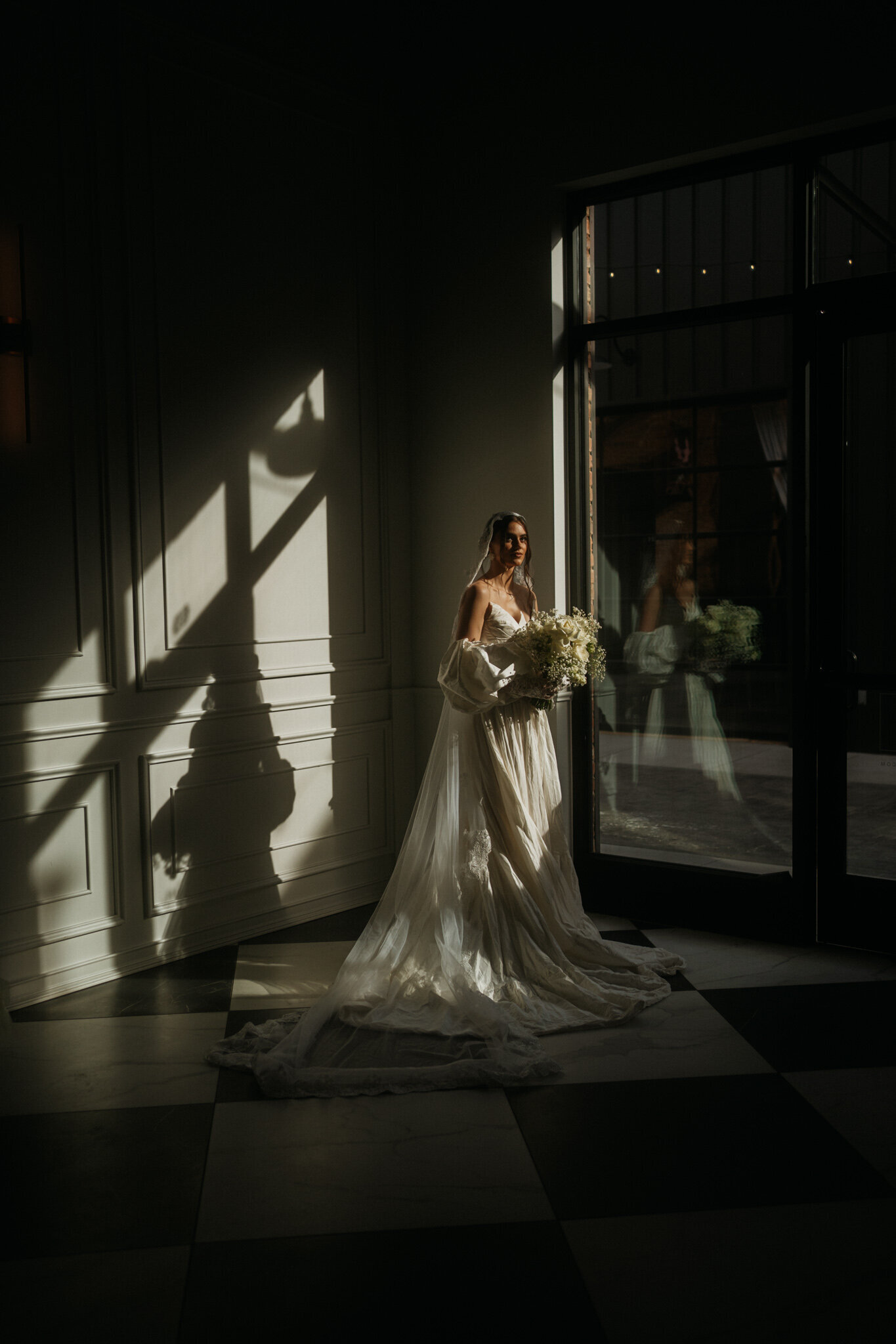 An Alabama bride photographed in stunning golden hour lighting holding her bouquet.