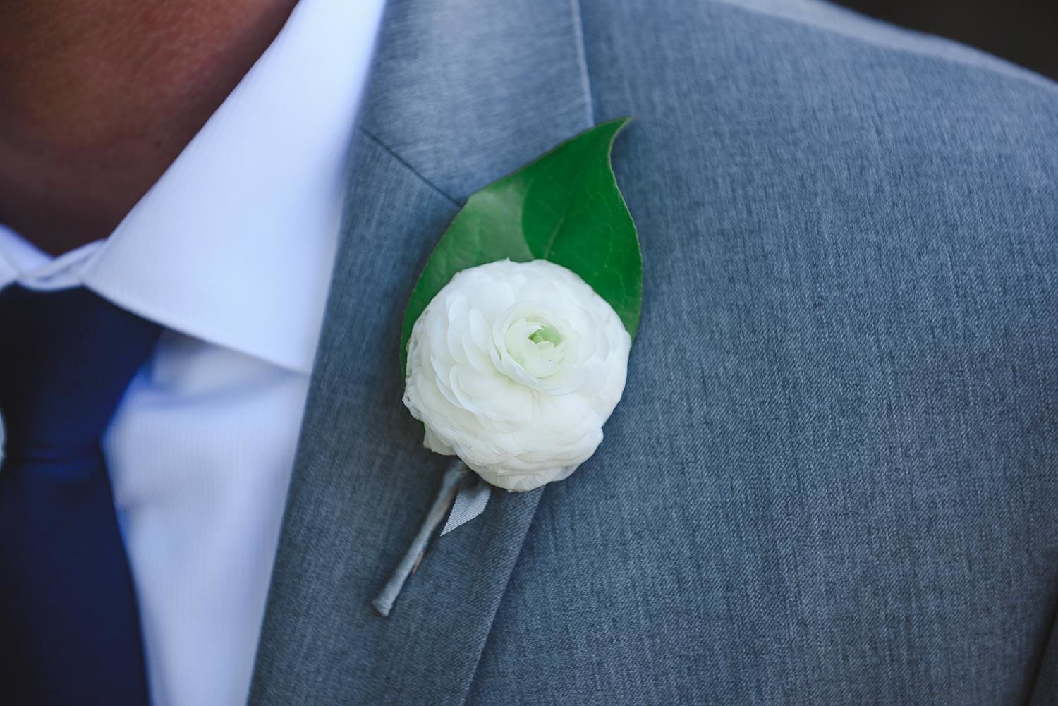 Rustic white ranunculus boutonniere at The Webb Barn in Wethersfield, CT