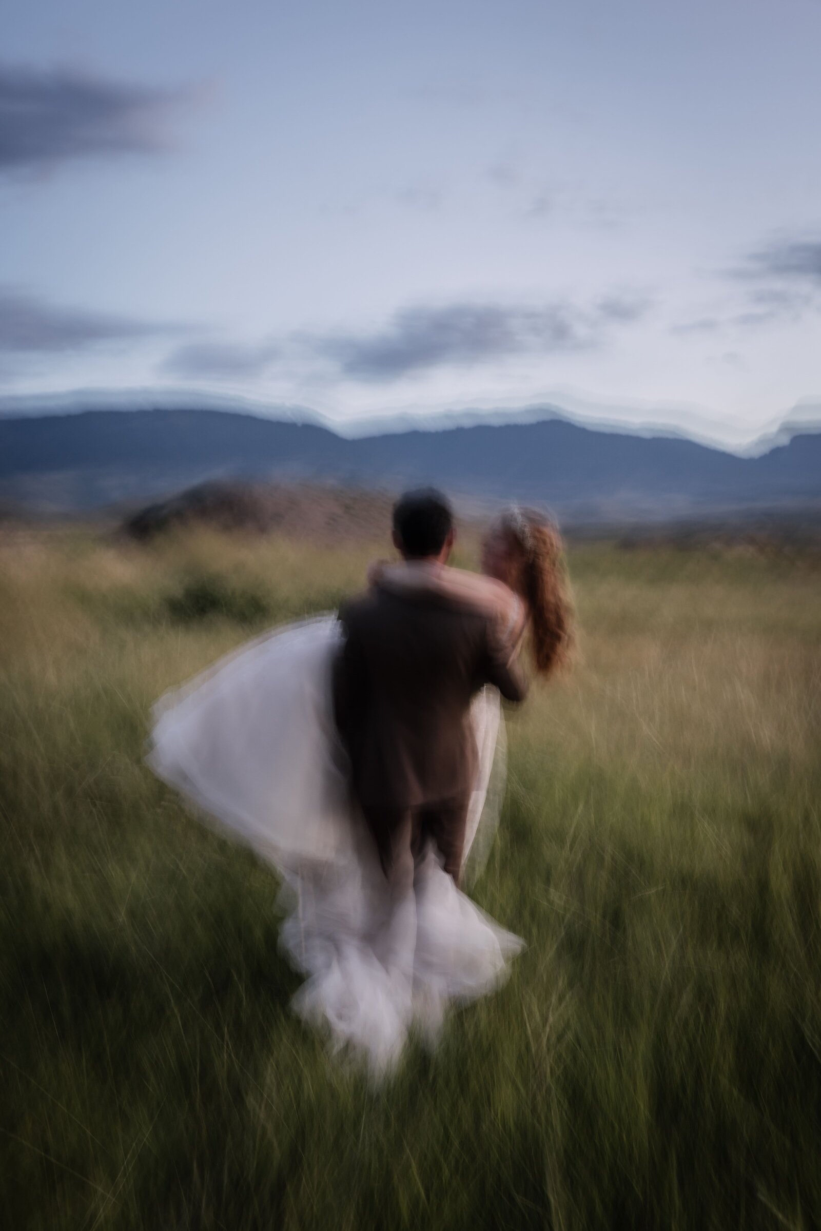 groom carrying bride away