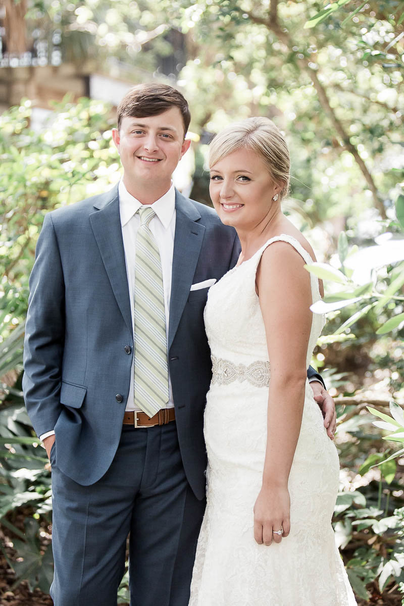 Bride and groom stand among palm trees, Wild Dunes, Charleston Wedding Photographer.