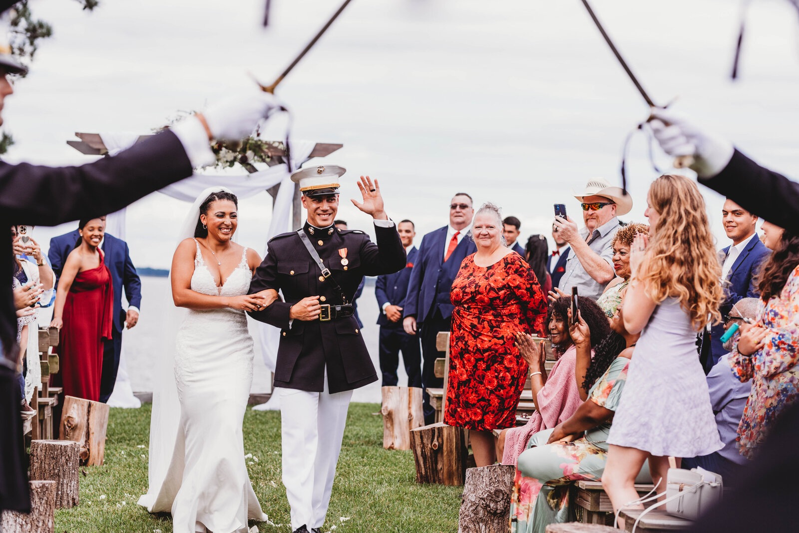 freshly married couple walking back down the aisle celebrated by the Marine Corps