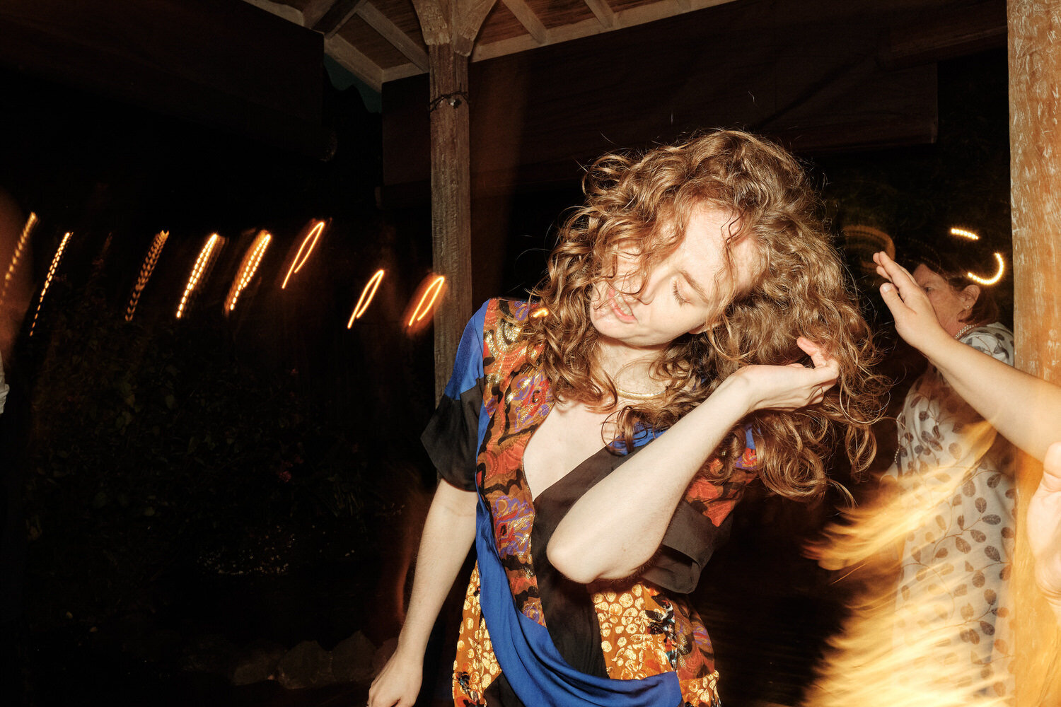 Wedding guest whips her hair on the dance floor, Stinson Beach, CA.