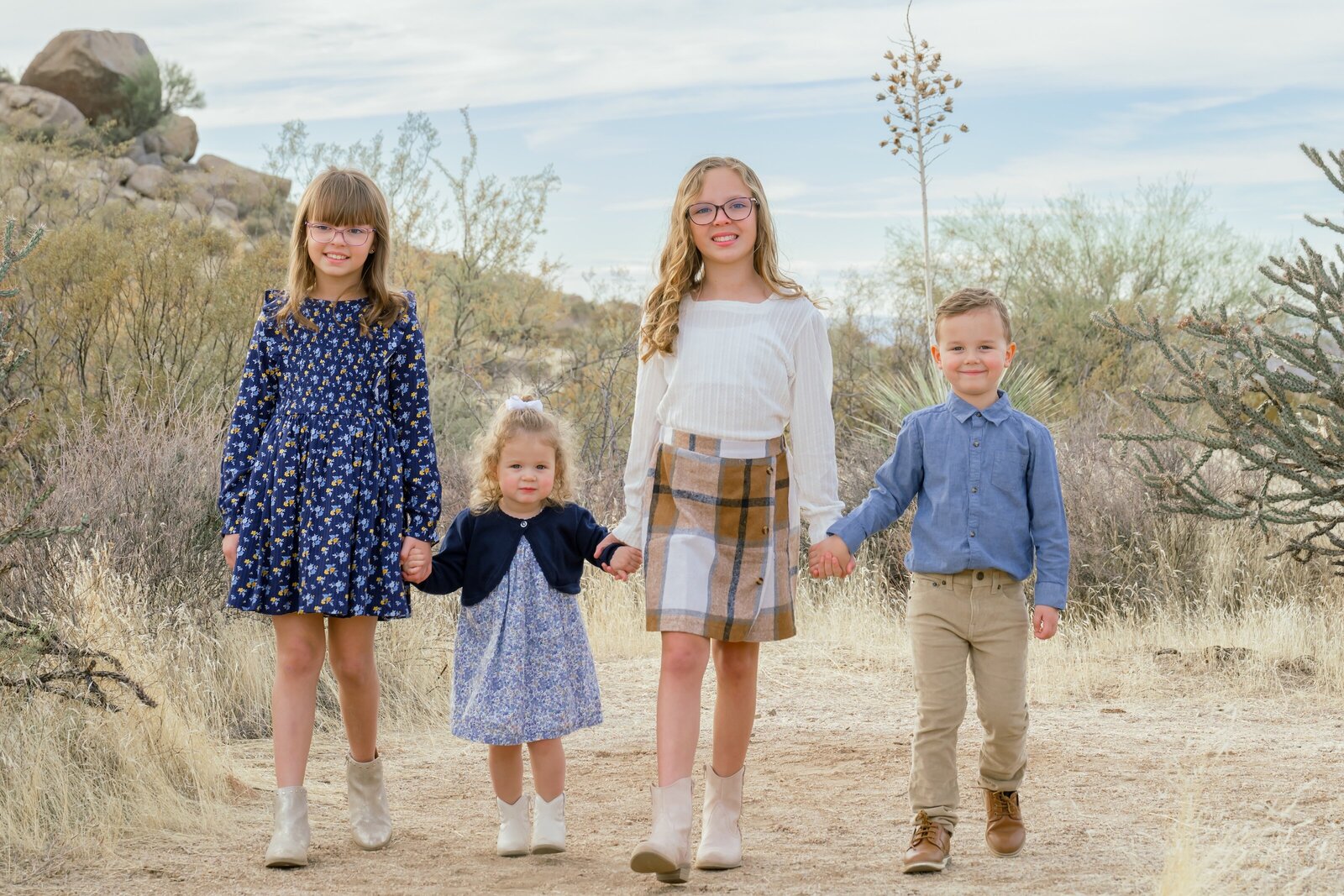 4 kids walking towards the camera in the arizona desert 