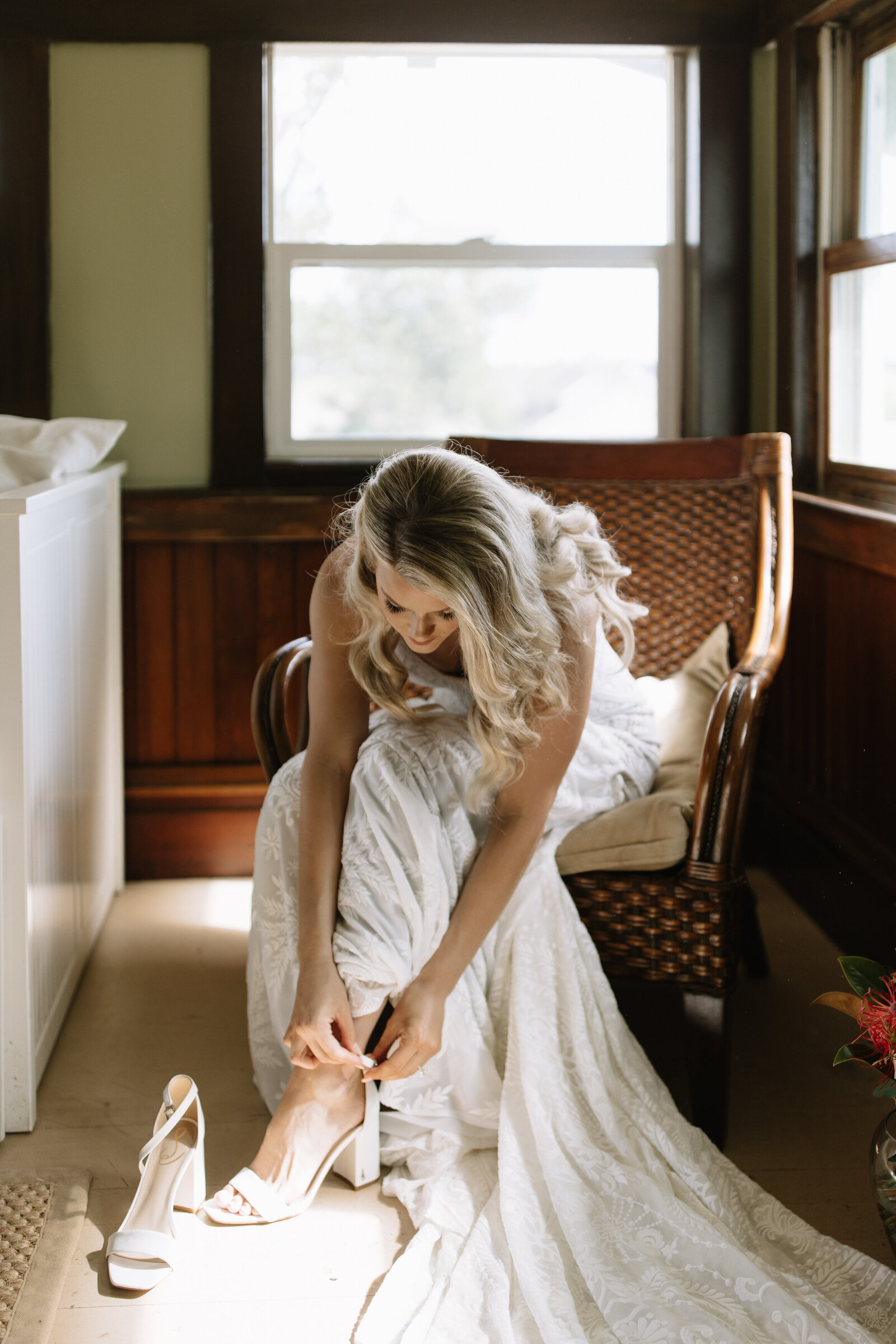 Bride putting on her heels during getting ready photos in Idaho bridal suite