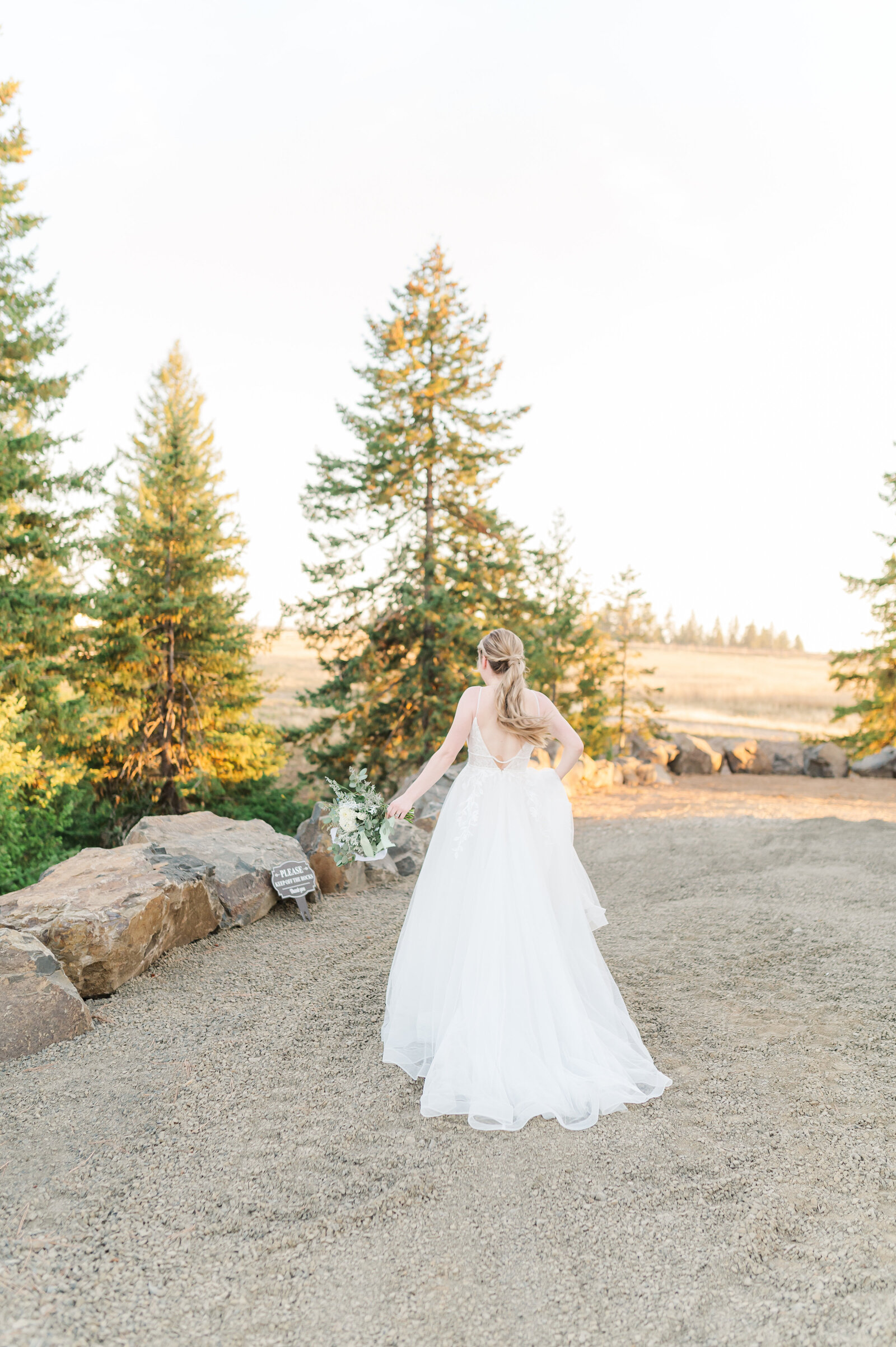 bride walking away at wedding venue in idaho called edge of heaven weddings and events